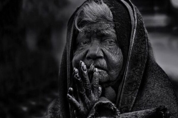 ELDER INDIAN WOMAN PRAYING